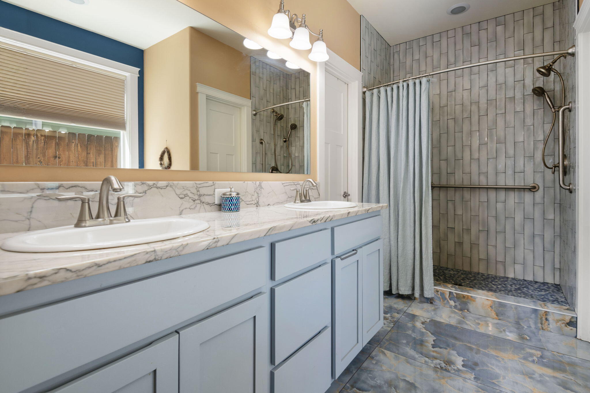 62944 Fresca Street Bend, OR 97703 - Photo 15 of 32 a bathroom with a double vanity sink mirror and shower