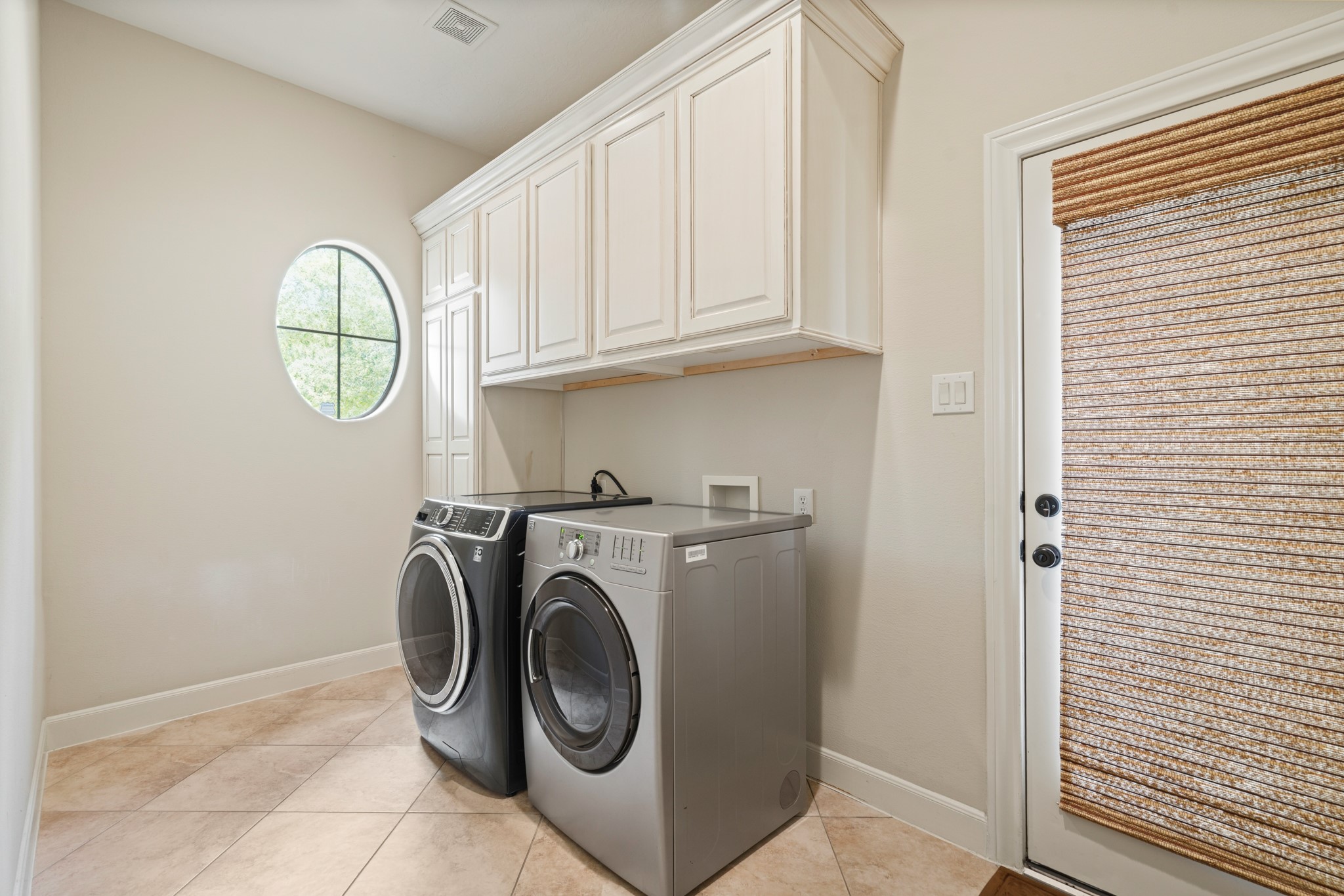 7303 Starry Night Katy, TX 77494 - Photo 27 of 49 Large laundry room with private driveway entry and built in cabinets.