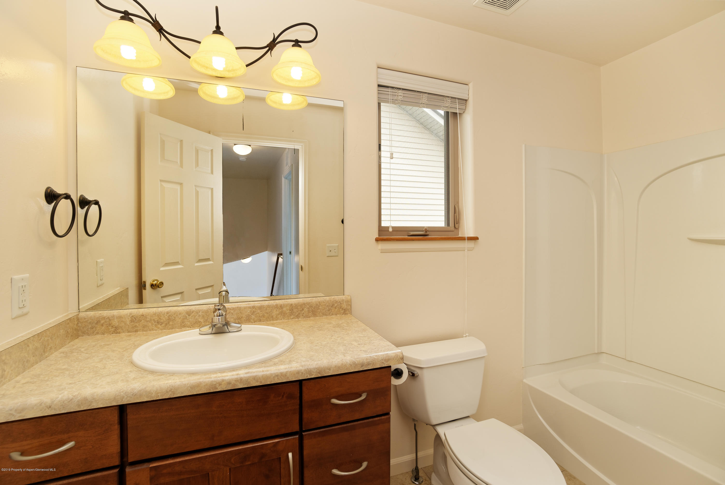 973 East 17th Street Rifle, CO 81650 - Photo 14 of 19 a bathroom with a sink toilet vanity and shower