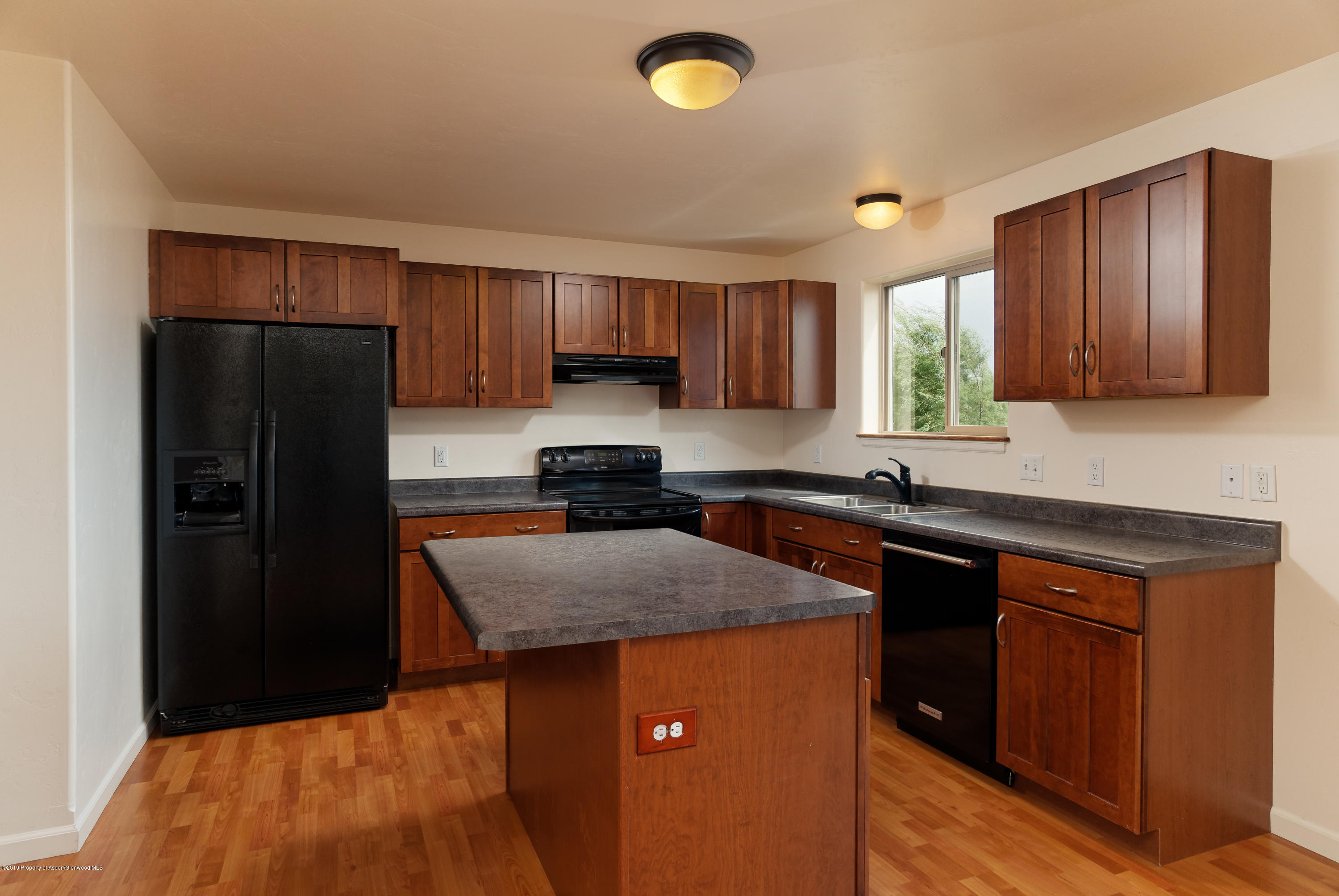 973 East 17th Street Rifle, CO 81650 - Photo 3 of 19 a kitchen with a refrigerator sink and cabinets