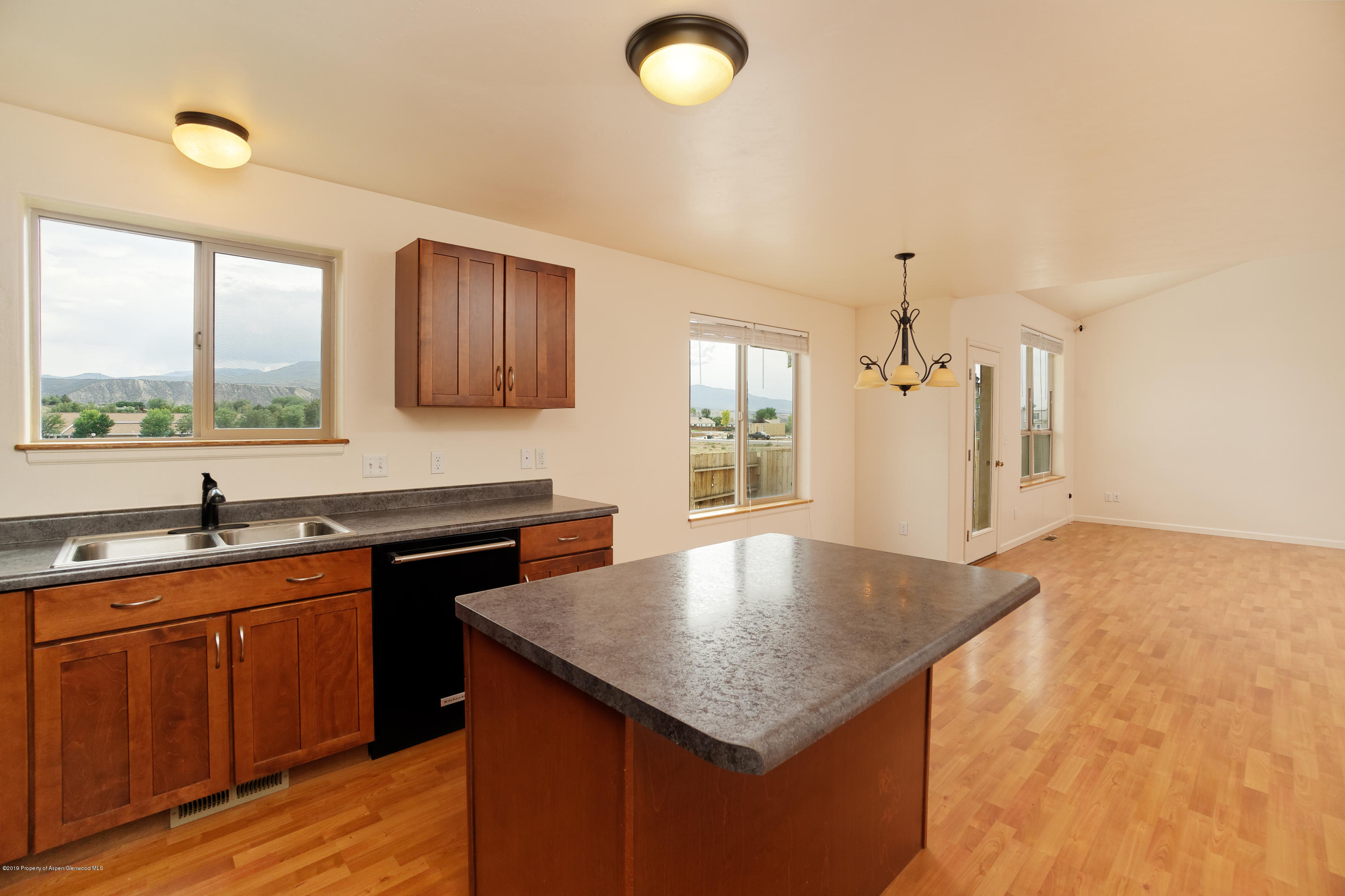 973 East 17th Street Rifle, CO 81650 - Photo 4 of 19 a kitchen with granite countertop a sink and cabinets