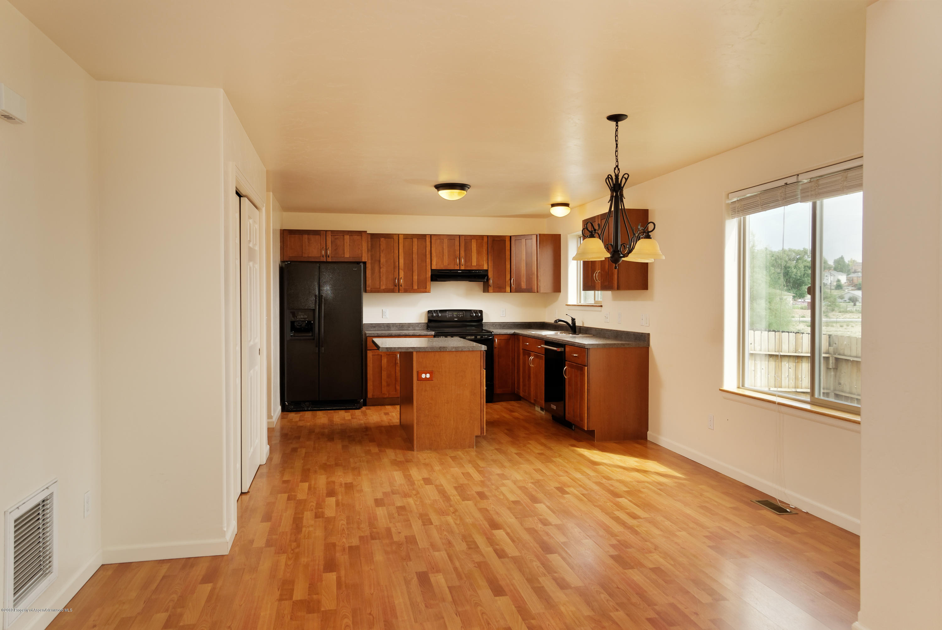 973 East 17th Street Rifle, CO 81650 - Photo 5 of 19 a kitchen with stainless steel appliances granite countertop a sink and a refrigerator