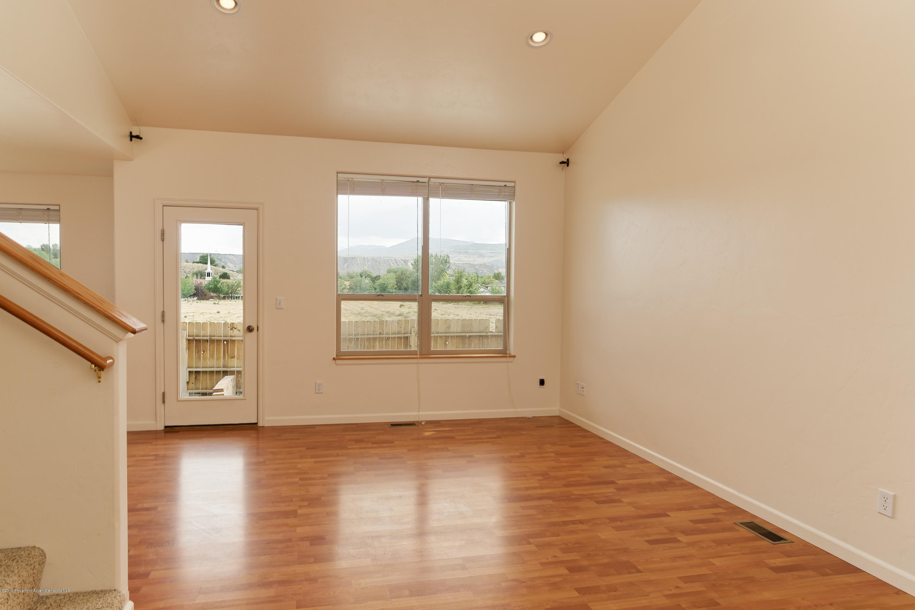 973 East 17th Street Rifle, CO 81650 - Photo 7 of 19 a view of an empty room with wooden floor and a window