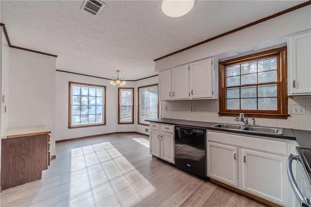 a kitchen with a sink stove and cabinets