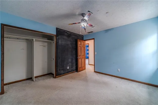 a view of an empty room with a chandelier
