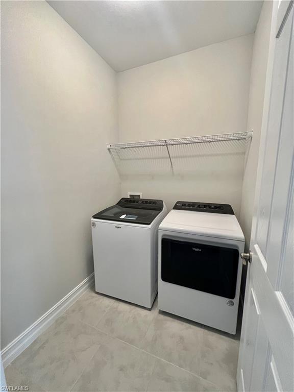 842 Enbrook Loop Naples, FL 34114 - Photo 14 of 23 a utility room with dryer and washer
