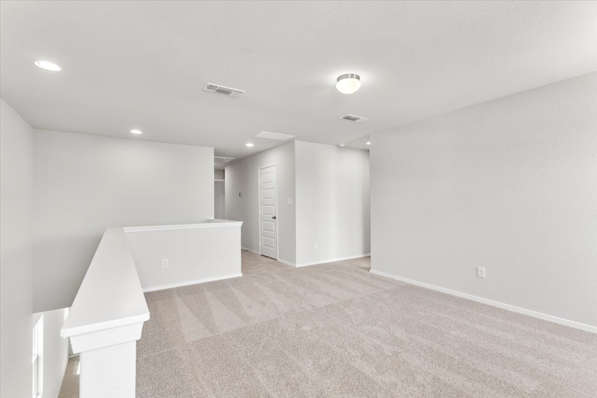 2601 Totley Road Pflugerville, TX 78660 - Photo 21 of 40 Carpeted empty room with recessed lighting and baseboards