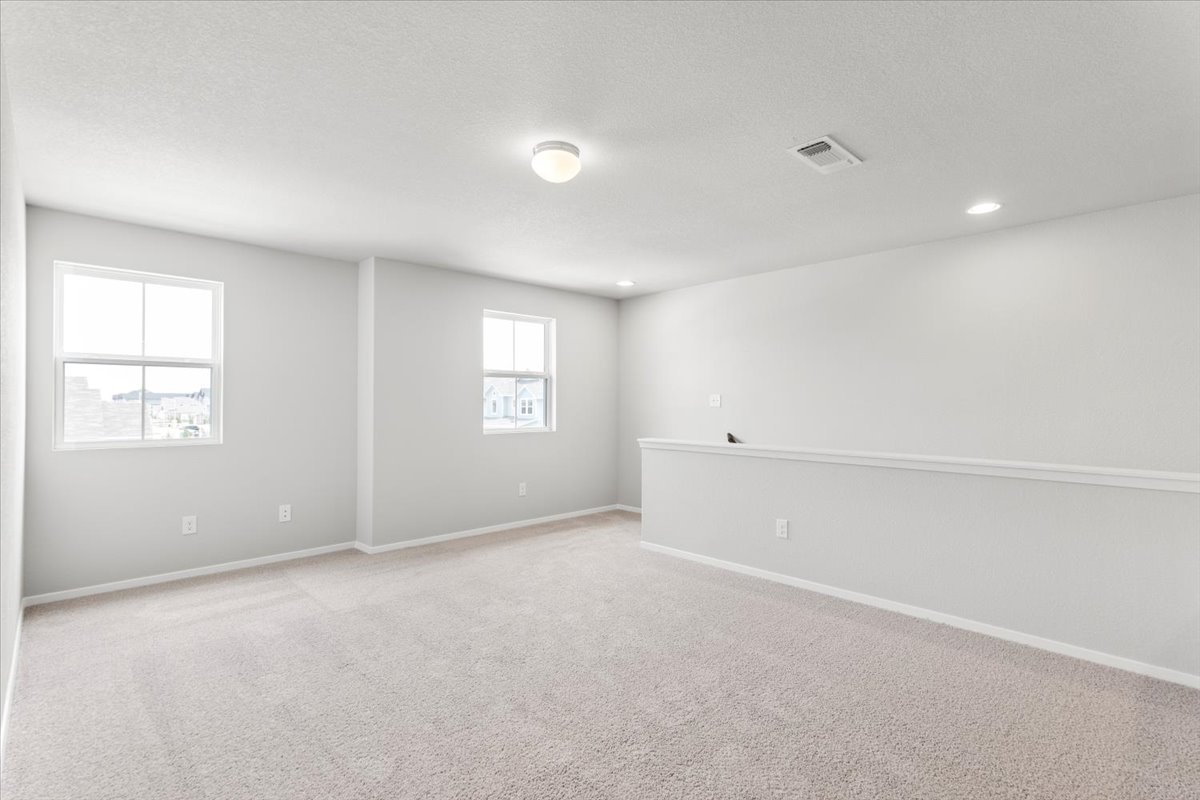 2601 Totley Road Pflugerville, TX 78660 - Photo 22 of 40 Empty room featuring light carpet, a textured ceiling, and recessed lighting