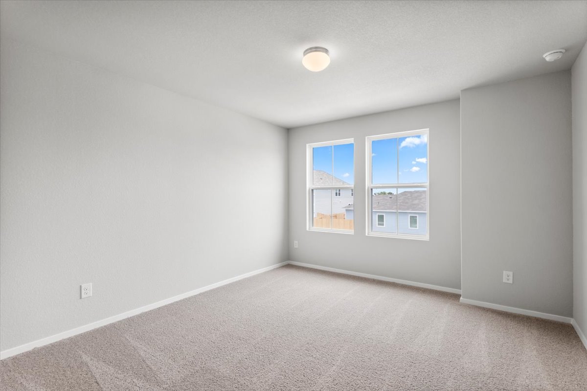 2601 Totley Road Pflugerville, TX 78660 - Photo 23 of 40 Empty room with carpet flooring and a smoke detector
