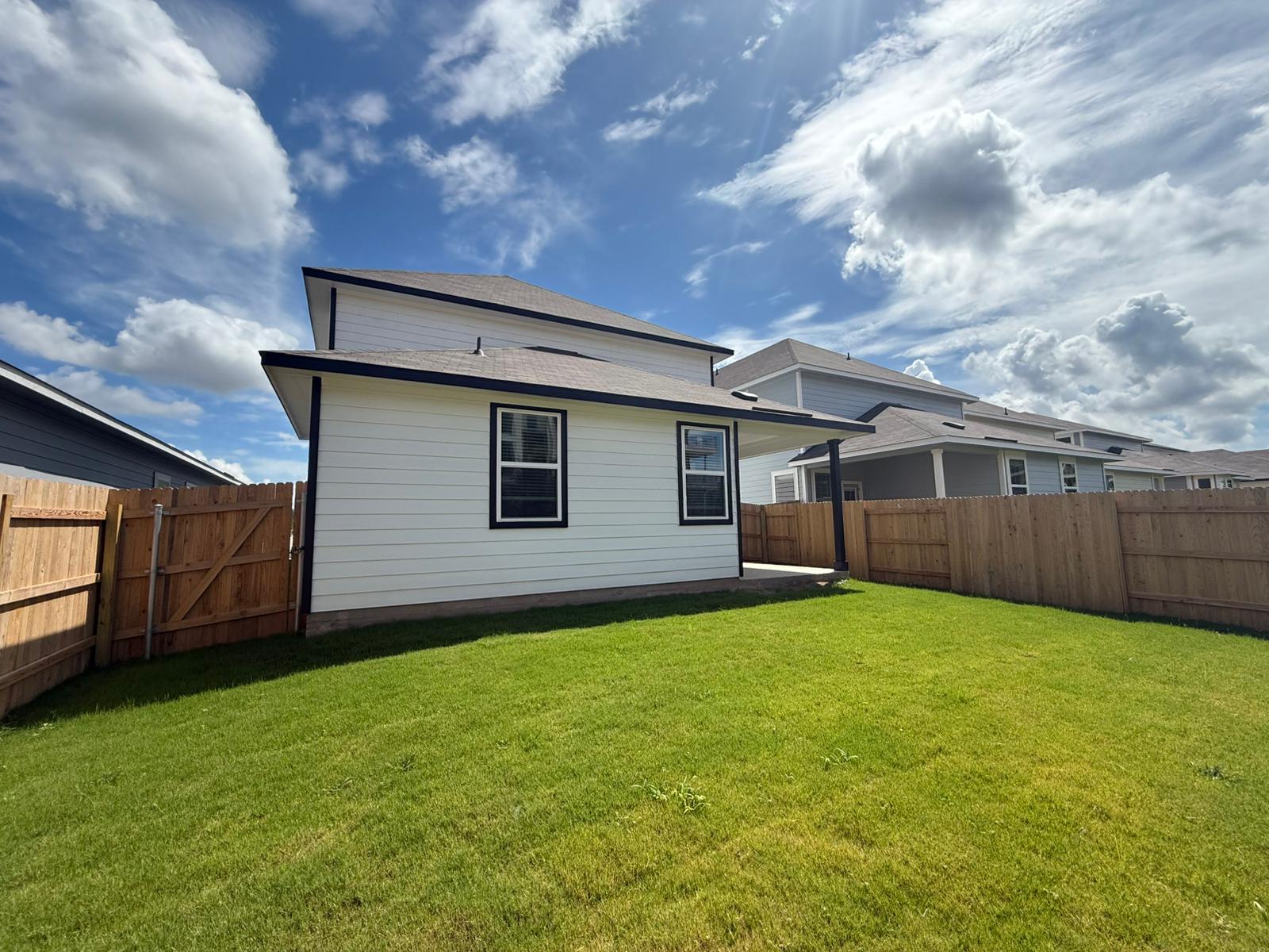2601 Totley Road Pflugerville, TX 78660 - Photo 36 of 40 Rear view of house with a fenced backyard and a gate