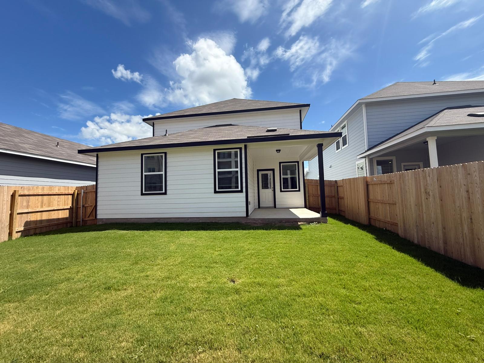 2601 Totley Road Pflugerville, TX 78660 - Photo 37 of 40 Rear view of property featuring a fenced backyard, roof with shingles, and a patio