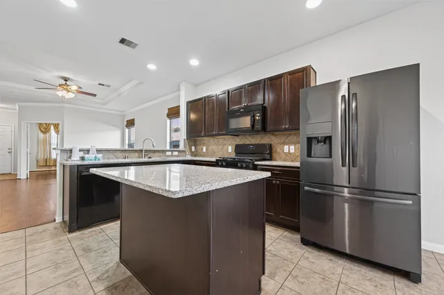 a view of wooden floor and chandelier fan in a room