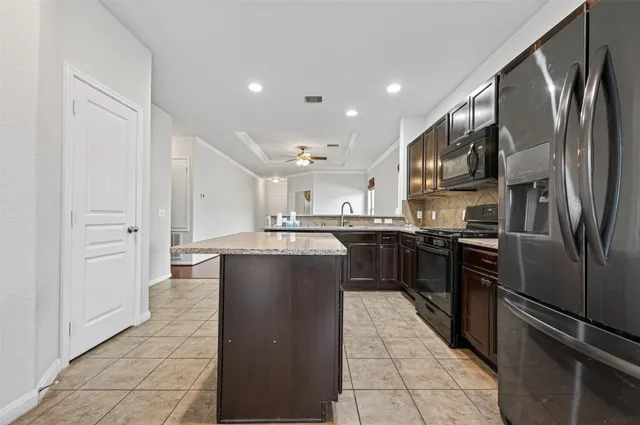 a view of a house with backyard and a tree