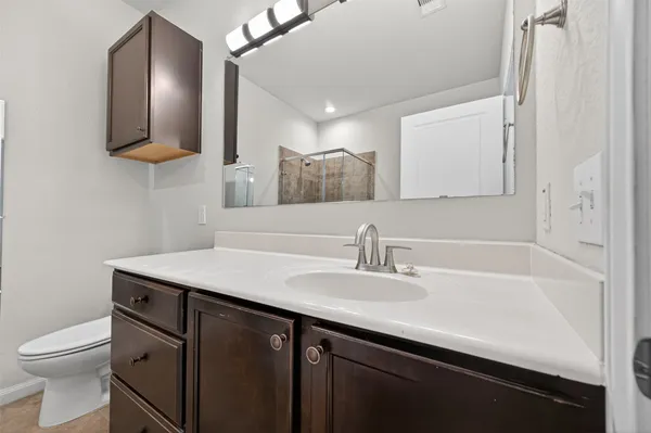 a bathroom with a sink a toilet and mirror