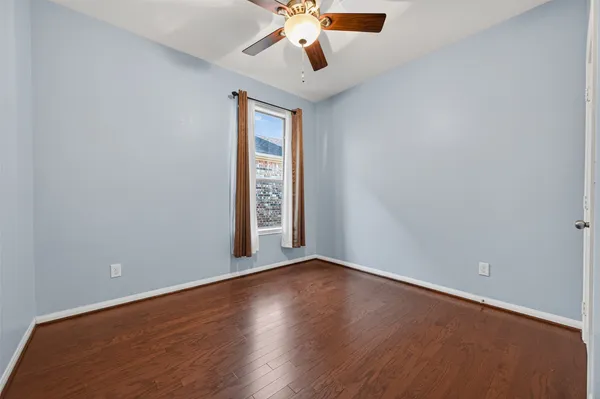 a view of a room with wooden floor