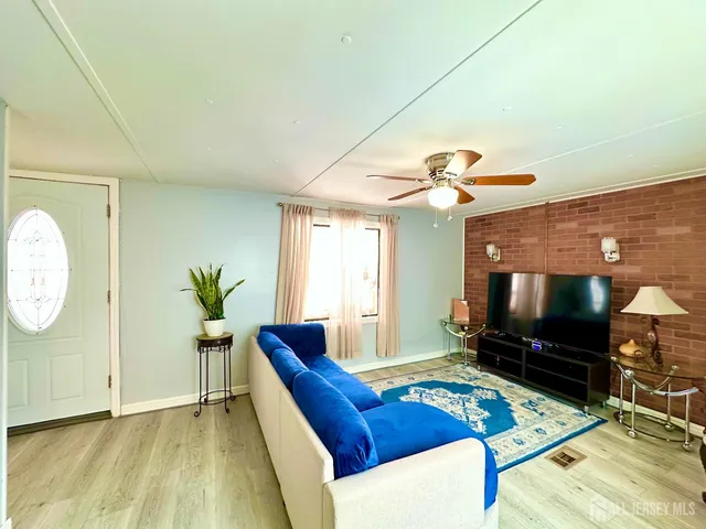 a bedroom with a bed a mirror and dresser