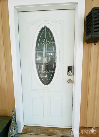 a kitchen with stainless steel appliances granite countertop a refrigerator a stove top oven a sink dishwasher and white cabinets with wooden floor