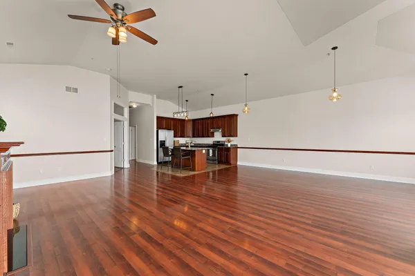 a view of an empty room with wooden floor