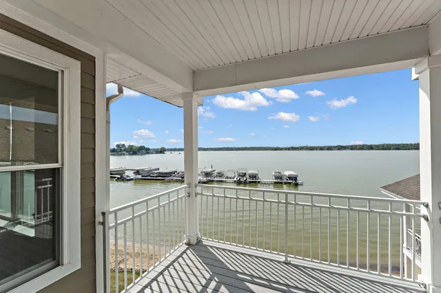 a view of balcony with floor to ceiling windows with wooden floor