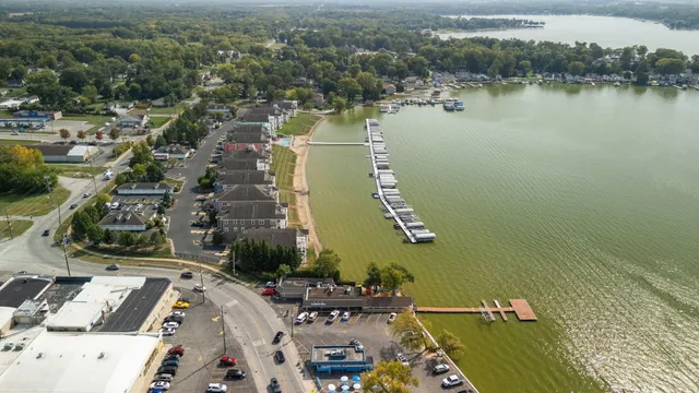 an aerial view of a house with a lake view