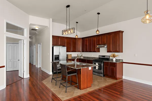 a view of a dining room with furniture wooden floor and chandelier