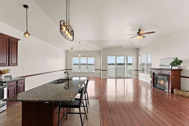 a view of a kitchen with a table and chairs in it