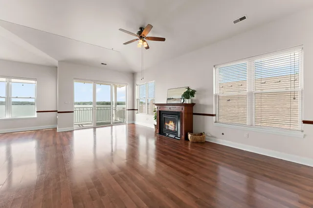 a view of empty room with wooden floor and fireplace