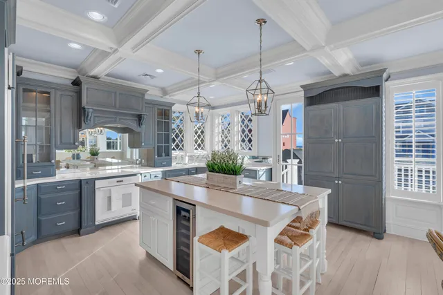 a kitchen with granite countertop a sink a counter space appliances and cabinets