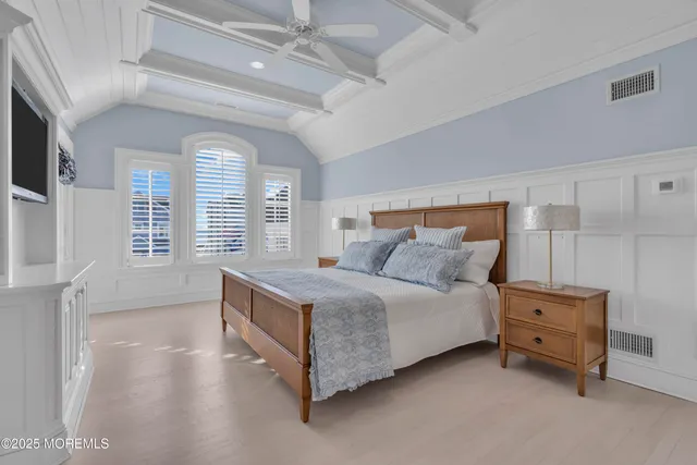 a spacious bedroom with a bed and a cabinets