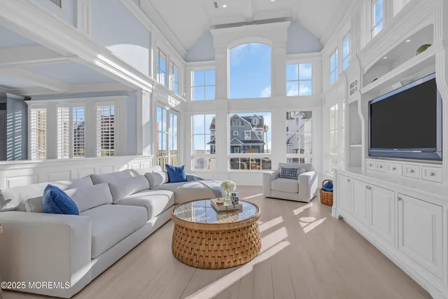 a living room with furniture a flat screen tv and a flat screen tv