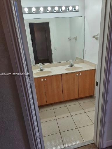 2160 Northeast 37th Road, Unit 2160 Homestead, FL 33033 - Photo 36 of 47 a bathroom with a granite countertop sink and mirror
