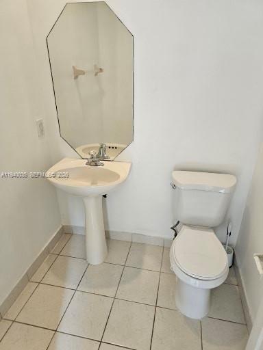 2160 Northeast 37th Road, Unit 2160 Homestead, FL 33033 - Photo 4 of 47 a bathroom with a toilet a sink and a mirror