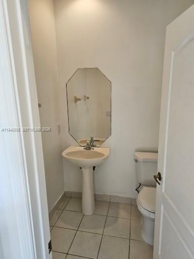 2160 Northeast 37th Road, Unit 2160 Homestead, FL 33033 - Photo 5 of 47 a bathroom with a sink toilet and a mirror