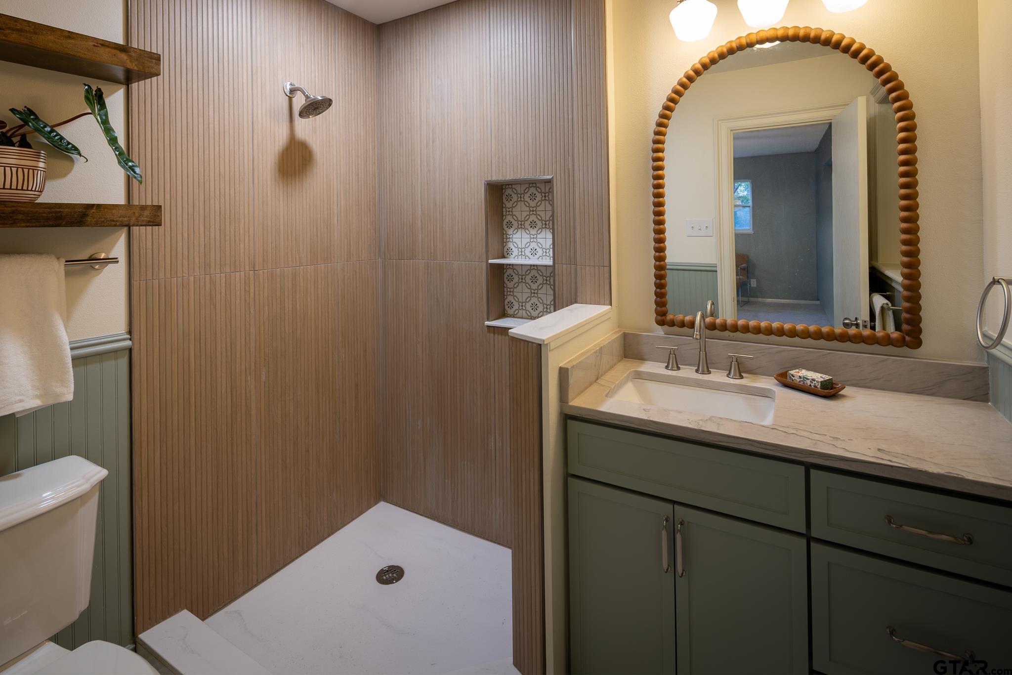 3518 Bain Place Tyler, TX 75701 - Photo 24 of 44 a bathroom with a sink and mirror with toilet