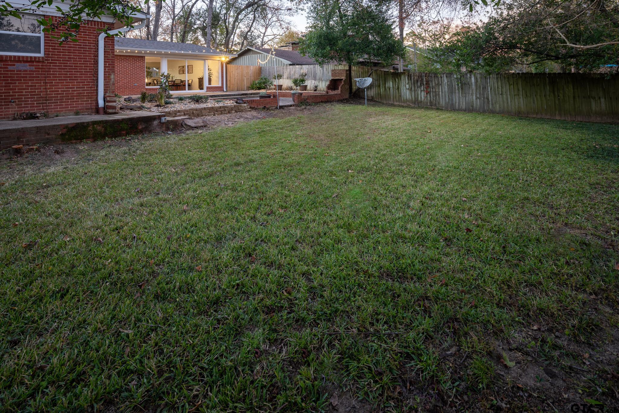 3518 Bain Place Tyler, TX 75701 - Photo 33 of 44 a backyard of a house with lots of green space and lake view