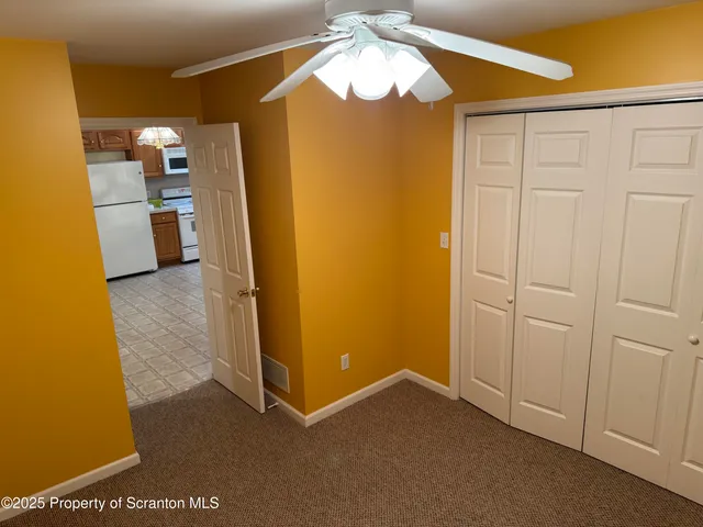 a view of a kitchen with a refrigerator and a stove