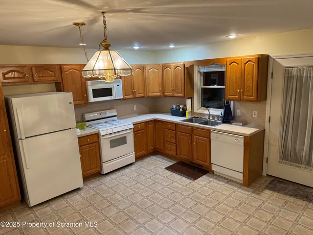 a kitchen with a sink appliances and cabinets