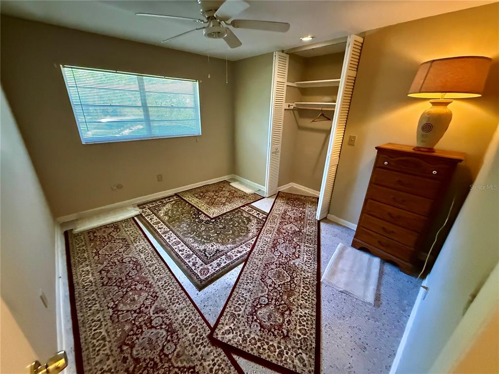 1004 Connecticut Road Tarpon Springs, FL 34689 - Photo 33 of 57 a bedroom with a bed and wooden floor