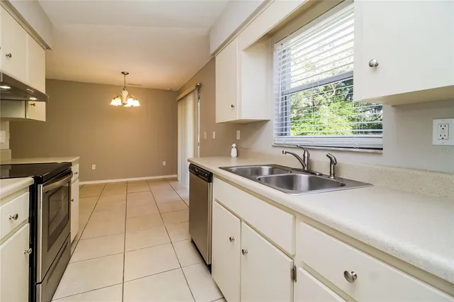 a kitchen with stainless steel appliances a stove a sink and a refrigerator