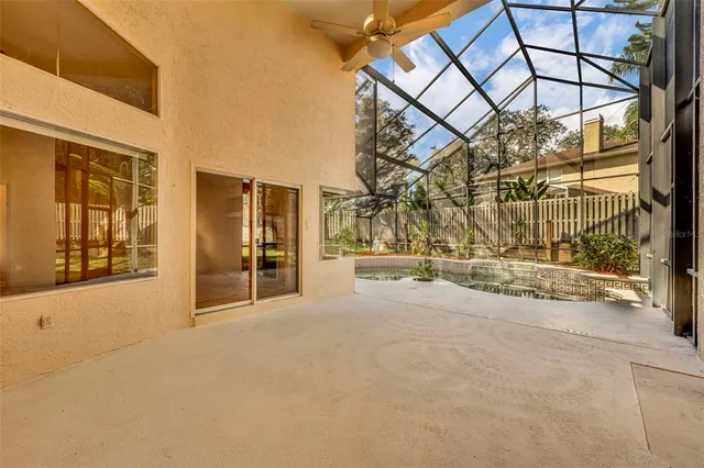 a view of swimming pool with a yard and large tree