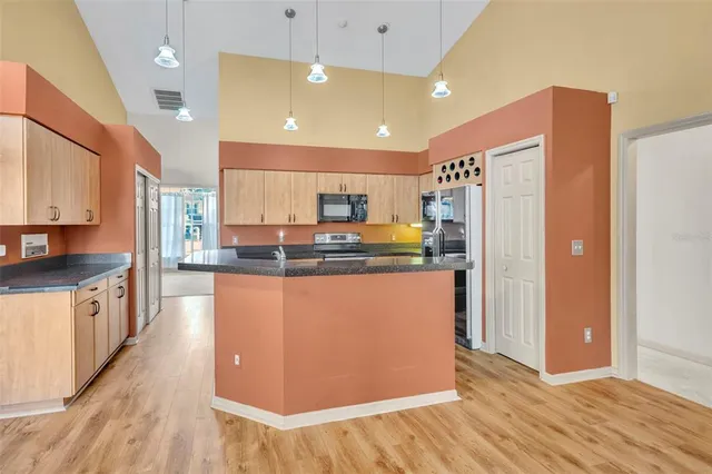 a view of a kitchen with a sink and a refrigerator