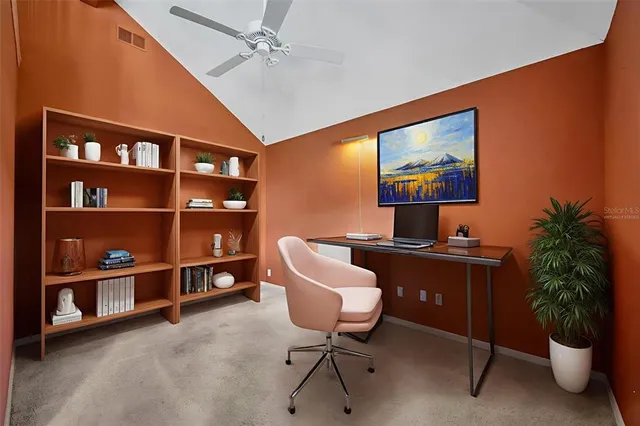 an aerial view of residential houses with outdoor space and trees