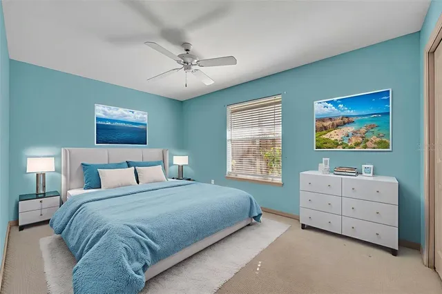 an aerial view of residential houses with outdoor space and trees