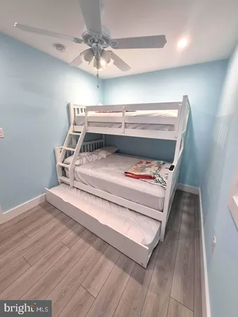 a bed sitting in a room next to a chandelier