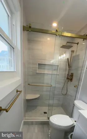 a bathroom with a toilet and shower