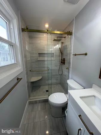 a bathroom with a toilet and a shower