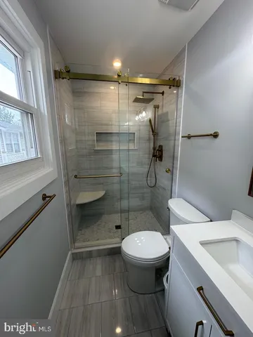 a bathroom with a toilet and a shower