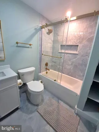 a bathroom with a toilet a sink and bathtub
