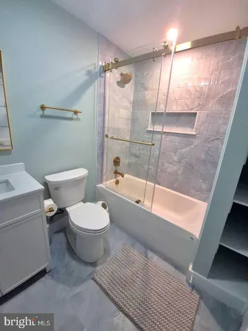 a bathroom with a toilet a sink and bathtub