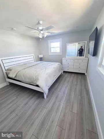 a bedroom with a large bed a chandelier and a window